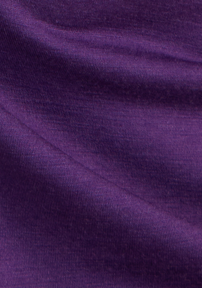 Close-up of the soft, smooth Plum Crush fabric from the Woolx Mia V Neck, showing gentle folds and subtle shading variations that highlight the premium Merino wool texture and weave.