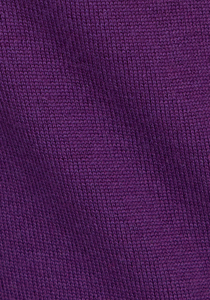 Close-up of the Woolx Anna Crew Sweater in Plum Crush, highlighting the intricate texture and pattern of the soft merino wool fabric with its ribbed appearance and visible stitching.