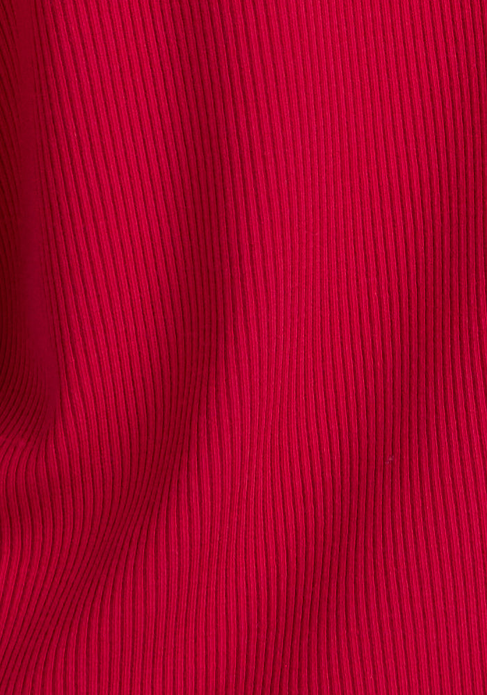 Close-up of the Woolx Sloane Ribbed Tank in Poppy Spark. The red Merino wool fabric has a vertical ribbed texture with subtle ridges and folds, adding depth and dimension to this women's scoop neck tank.