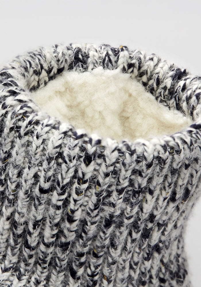 Close-up of the Woolx Women's Gripper Slipper Booties in Speckled Stone, featuring a soft sherpa lining for extra warmth and non-slip grippers for secure steps on any surface.