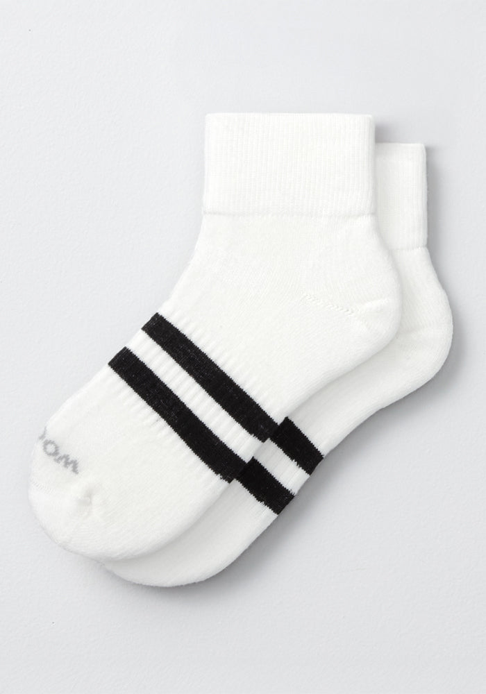 The Woolx Womens Rambler Ankle Sock in Polar White features two black stripes near the toes and is crafted from Merino wool for superior moisture management, shown against a light gray background.