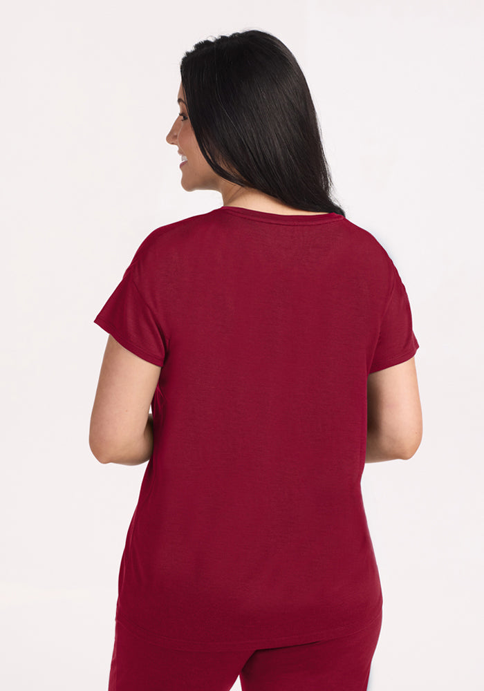 Woman from behind wearing a beet red Billie Lounge Tee, a moisture-wicking merino wool sleep top.
