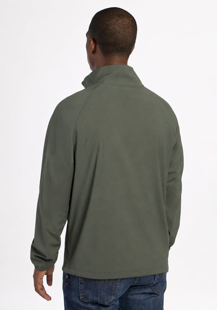 Back view of a person in a sage olive Woolx Dominator Windbreaker - Sage Olive with a high collar and elastic cuffs.