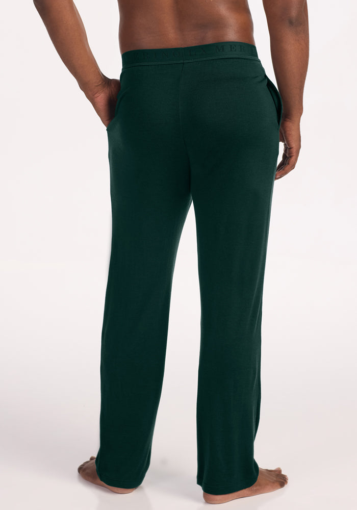 Back view of a person wearing deep pine Arlo Lounge Pants with a lightweight design and an elastic waistband.