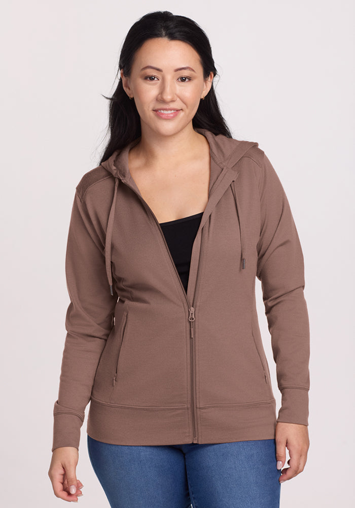 Smiling woman in a Woolx Ryann Hoodie - Toasted Almond over a black top, against a plain light background. | Sarah is 5'8", wearing a size S
