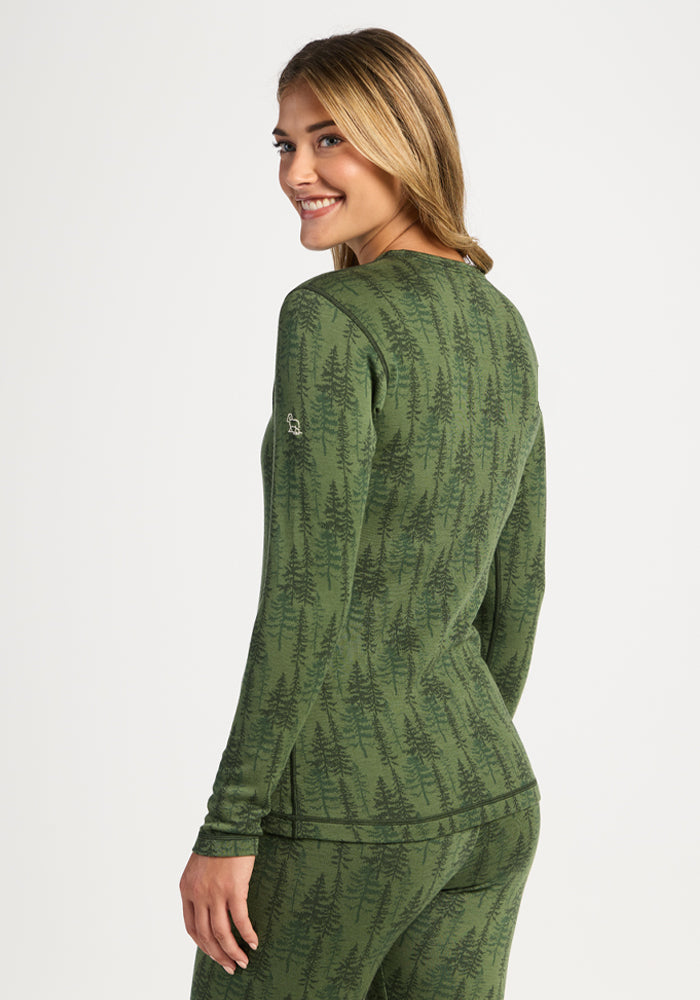 Smiling woman in Woolx Maddie Baselayer Top - Forest Friends, glancing over her shoulder.