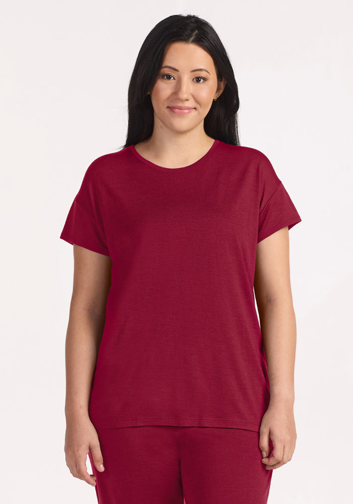 A woman wearing a moisture-wicking, beet red Billie Lounge Tee with short, relaxed sleeves. | Sarah is 5'8", wearing a size S