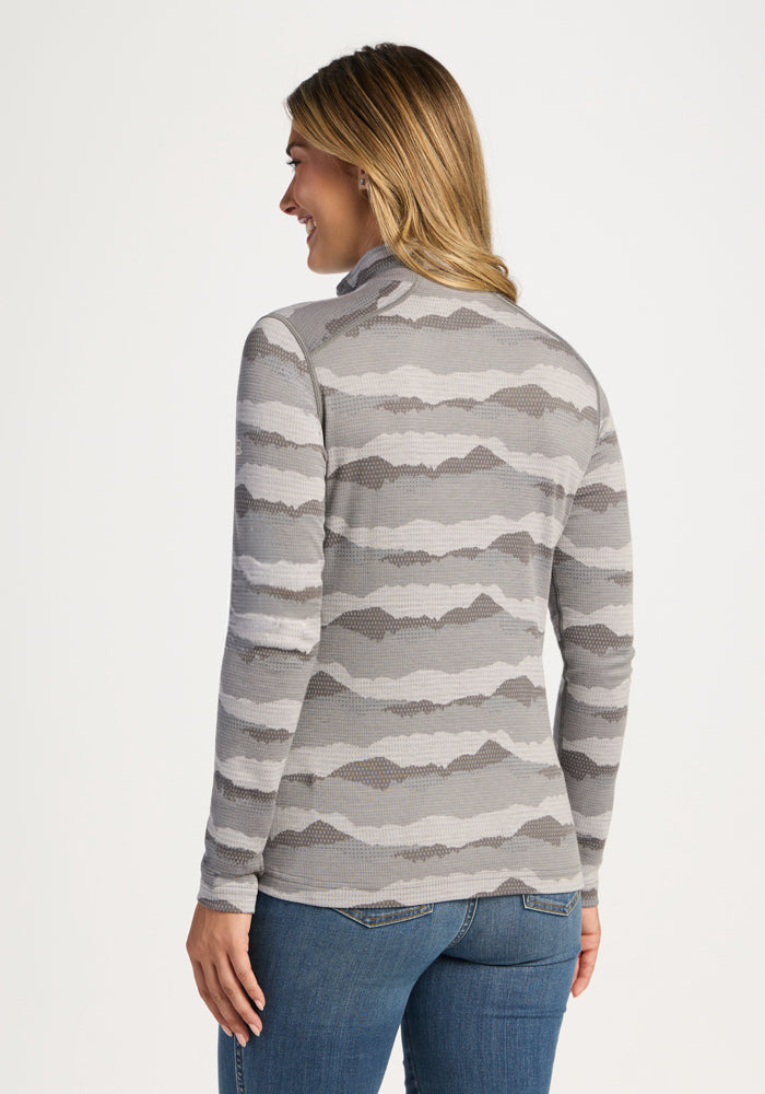 Woman wearing the Woolx Emi 1/4 Zip - High Peaks sweater, facing away from the camera.