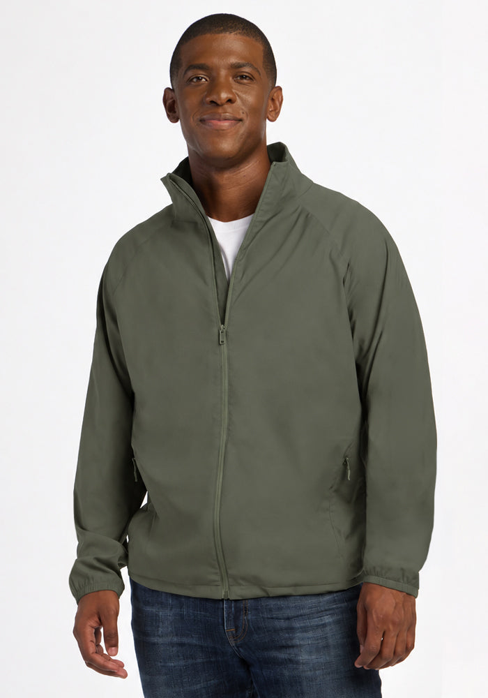 A man wearing a Sage Olive Woolx Dominator Windbreaker over a white t-shirt. 