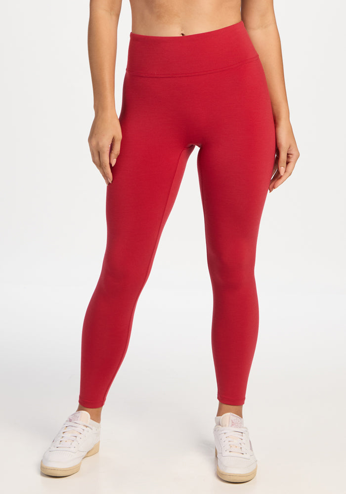 Person wearing high-waisted Angela Leggings - Maraschino Cherry and white sneakers. 