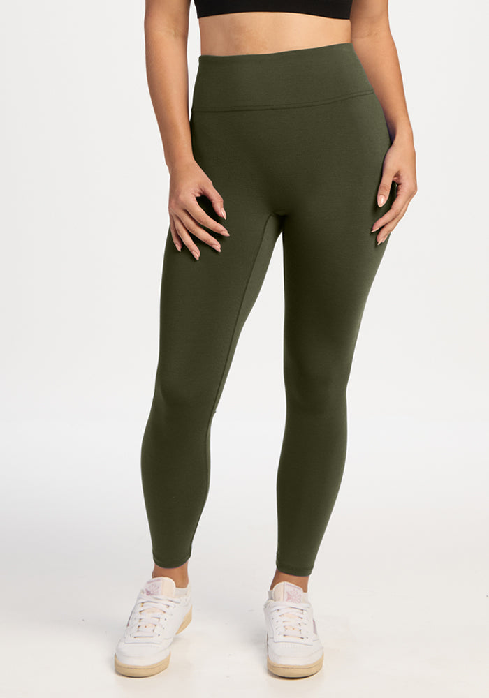 A person wearing olive green Angela Leggings - Everleaf and white sneakers. | Ariana is 5'11", wearing a size S