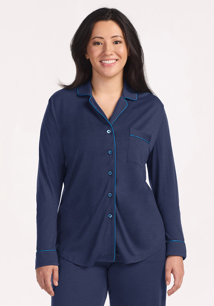 A woman wearing a navy blue Woolx Harper FeatherTouch® Pajama Set top with bright blue piping.