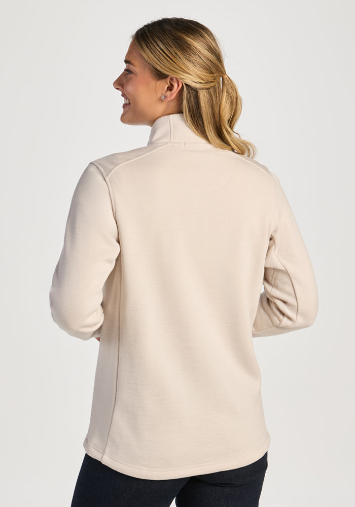 A woman seen from the back wearing an ecru Woolx Teddy Sweatshirt, an ultra-heavyweight merino wool mock-neck.
