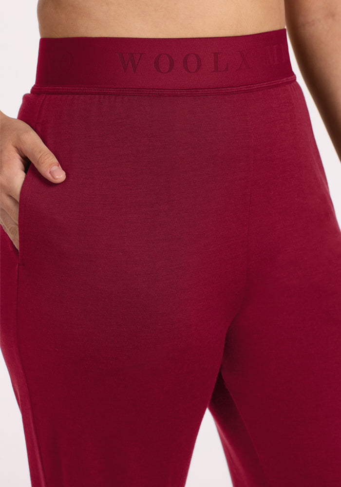 Close-up of beet red Maya Lounge Pants, featuring a wide leg, branded elastic waistband, and side pocket.