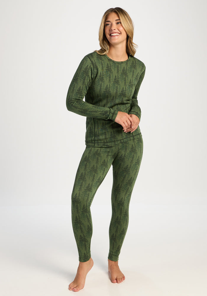 Barefoot and smiling, they wear the Woolx Maddie Baselayer Top - Forest Friends, feeling cozy in merino warmth.