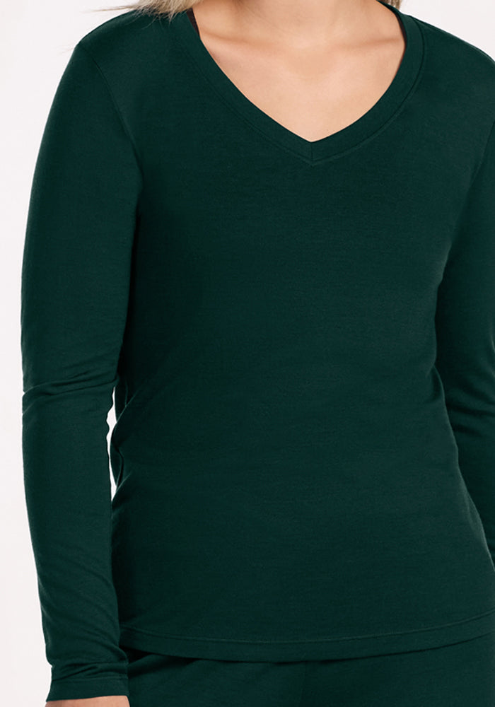 A long-sleeved, deep green V-neck Lily V Neck Lounge Top - Deep Pine in Merino wool.