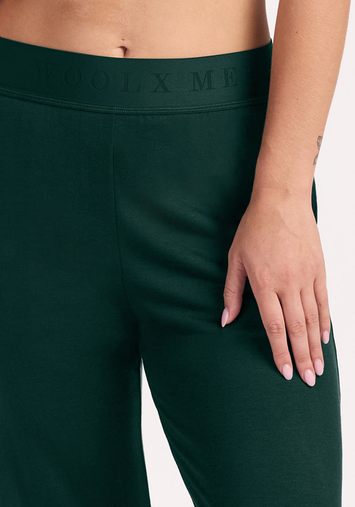 Close-up of deep pine Maya Lounge Pants with a wide, embossed-text waistband.