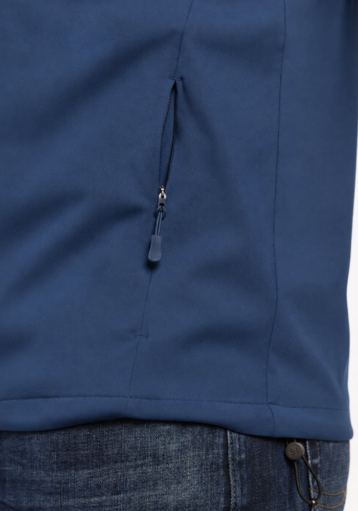 Close-up of a blue Woolx Dominator Windbreaker - Vintage Indigo featuring a zippered pocket.