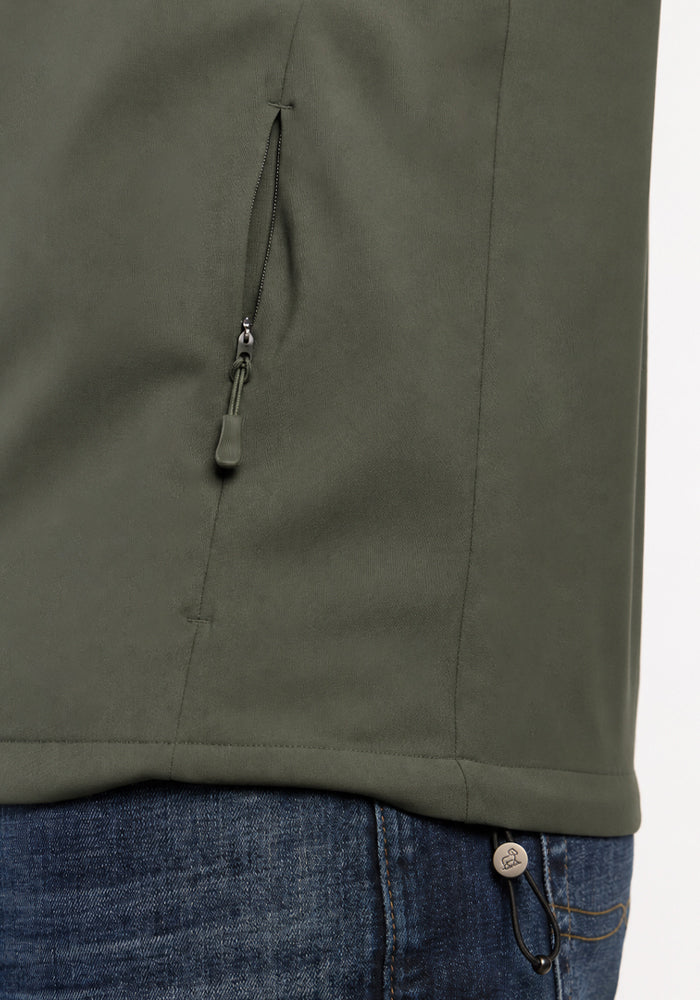 Close-up of a sage olive Woolx Dominator Windbreaker showing a zippered side pocket.