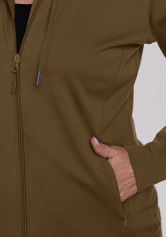 Model in a Woolx Ryann Hoodie - Olive Leaf, one hand in pocket, showcasing the torso and sleeve.