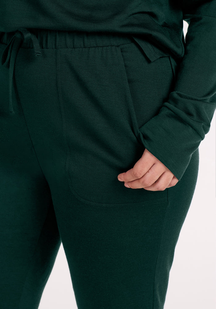 Woolx Mary Kate Lounge Pants in Deep Pine: dark green merino wool joggers with a drawstring waistband and side pockets.