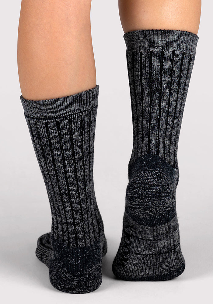 A close-up of two feet wearing Woolx Womens Joey Crew Socks in Stone Grey, featuring a ribbed, textured pattern. The mid-calf socks provide both style and comfort.