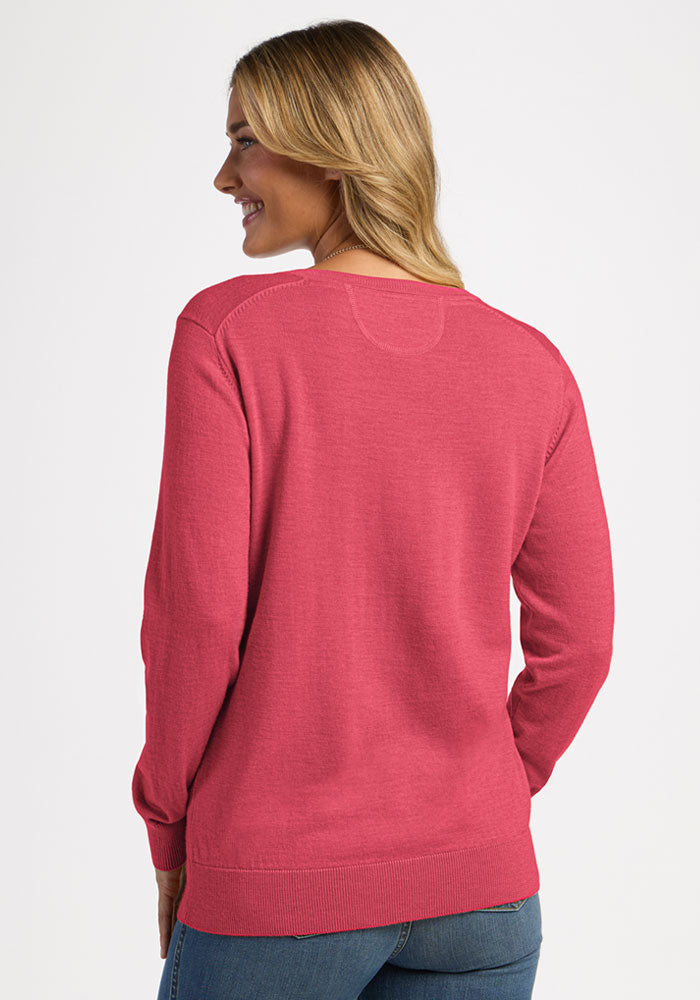 A woman from behind wears a vibrant pink, long-sleeved, crew-neck Woolx Francesca Sweater in Vivid Rose.