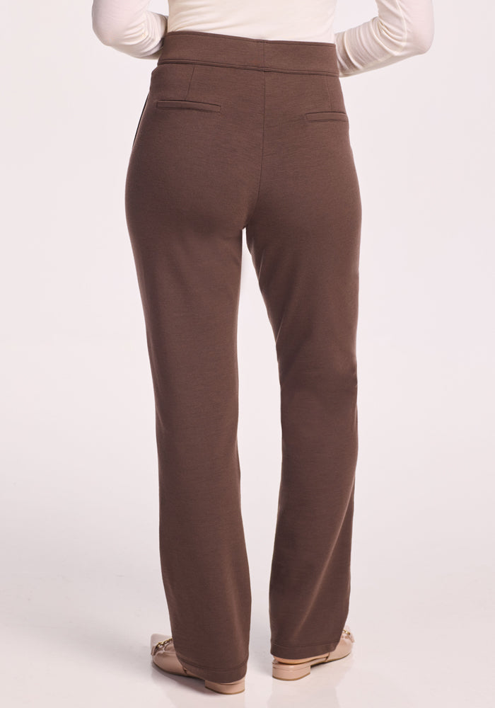 A person is seen from the back wearing Woolx Emerson Straight Leg Pants Petite in Bracken and a white long-sleeve top, standing on a light background.