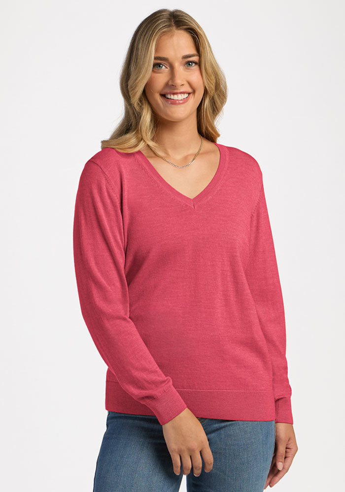 A woman wearing a bright pink V-neck Francesca Sweater - Vivid Rose in Merino wool. | Ariana is 5'11", wearing a size S