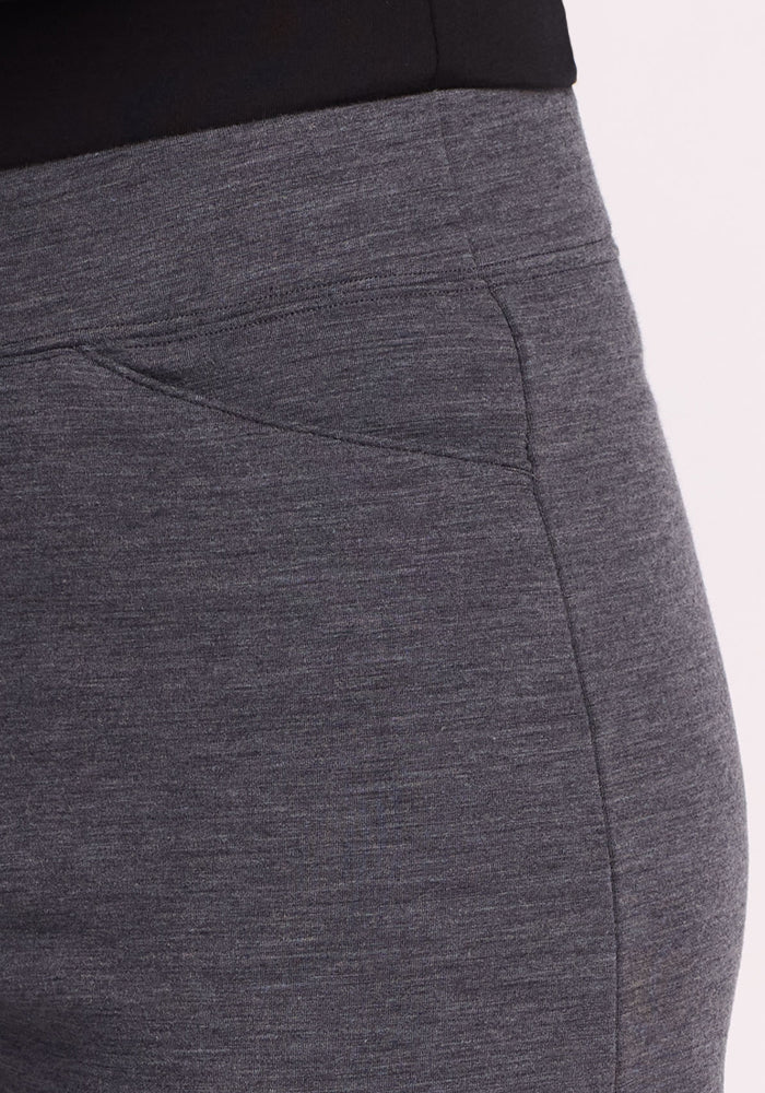 Close-up of a person wearing Woolx Ellie Wide Leg Pants in Cinder Melange. These gray, heathered Merino wool pants have a pocket and offer smooth texture, making them an ideal thermal choice for colder days.
