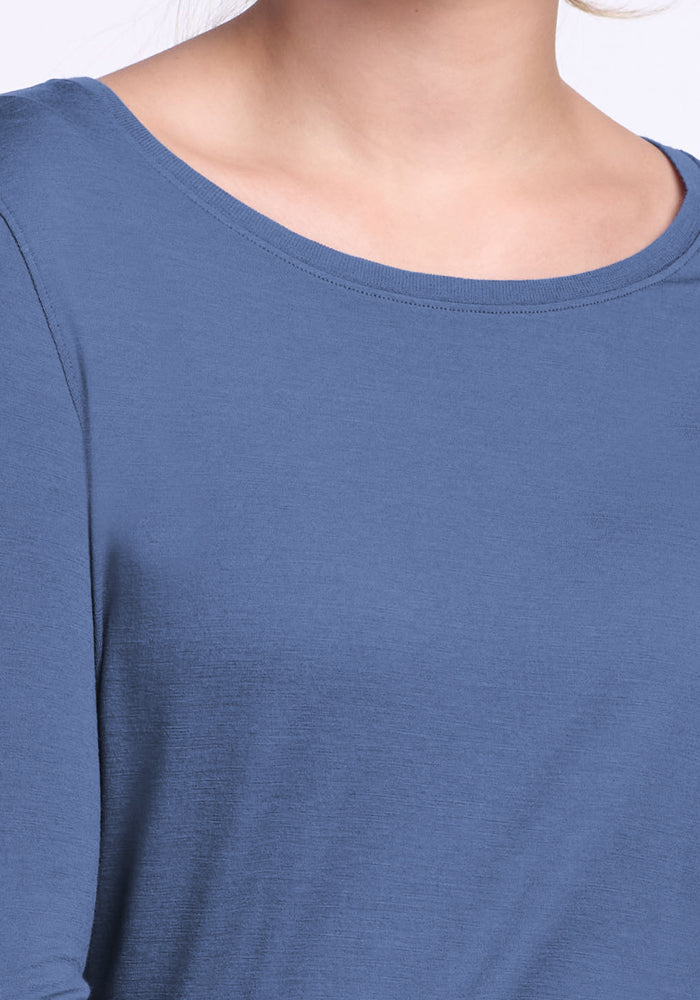 A close-up of a person wearing the Woolx Jenny 3/4 Sleeve Crew Neck in Skyline, cropped at the shoulders and chin to highlight the crew neckline and upper chest.