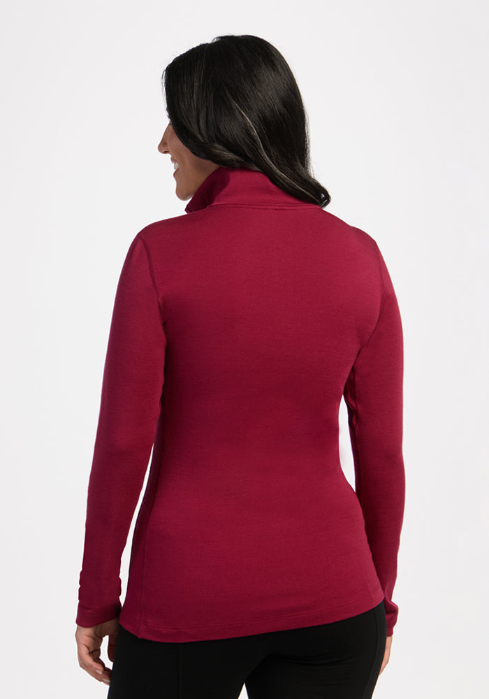 Woman with long dark hair wears the Woolx Brooke 1/4 Zip in Beet Red, shown from the back on a white background.