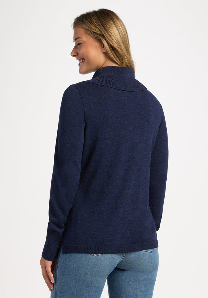 Woman smiles in Woolx Josie Cowl Neck Sweater—Ocean Cavern—shown from the back with light jeans.