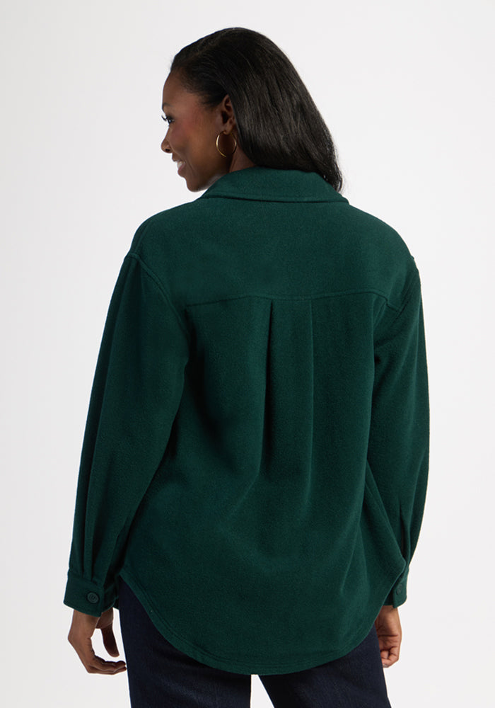 Woman in the Woolx Jovie Shacket - Deep Pine, facing away—an ideal cozy layer for cool days.