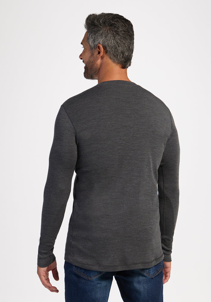 Man with short gray hair in Woolx Explorer Base Layer - Cinder Melange and blue jeans, facing away.