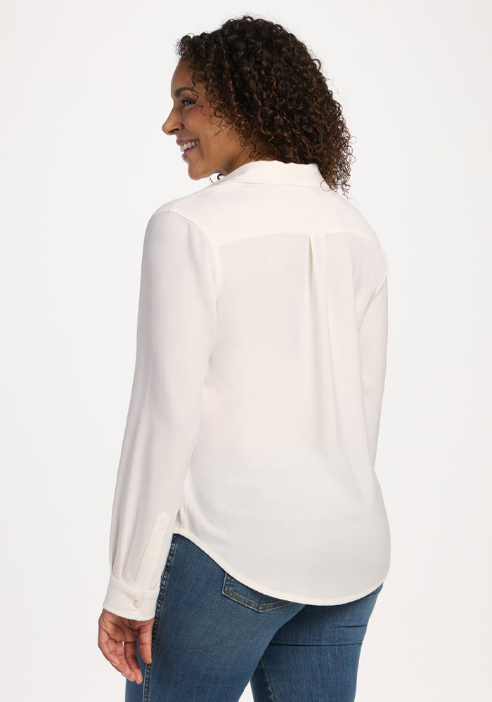 Woman in a Woolx Lorelai Button Up - Eggshell and blue jeans, smiling, facing away from the camera.