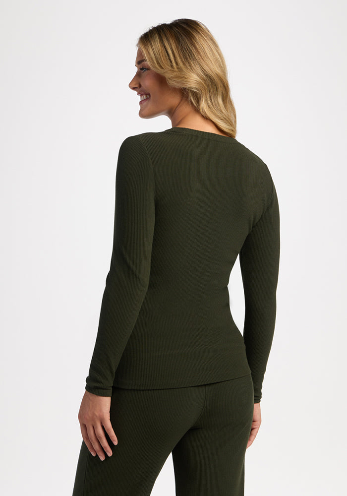 Woman with long blonde hair in the Woolx Hadley Petite Crew - Duffel Bag, smiling and facing away.