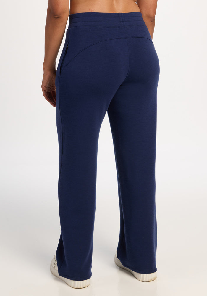 Person in Woolx Bree Lounge Pants - Ocean Cavern stands facing away, highlighting the relaxed fit on a white background.