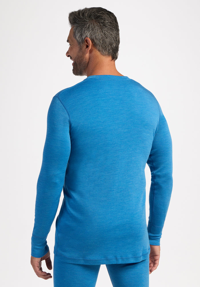 Man with gray hair wears Woolx Explorer Base Layer - Blue Razz, seen from behind against a white background.