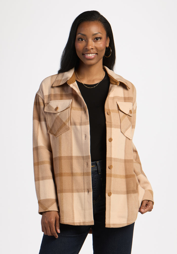 Woman in Woolx Sawyer Shacket - Saddleback Plaid over a black top and jeans, smiling warmly at the camera. | Jade is 5’10”, wearing a size S