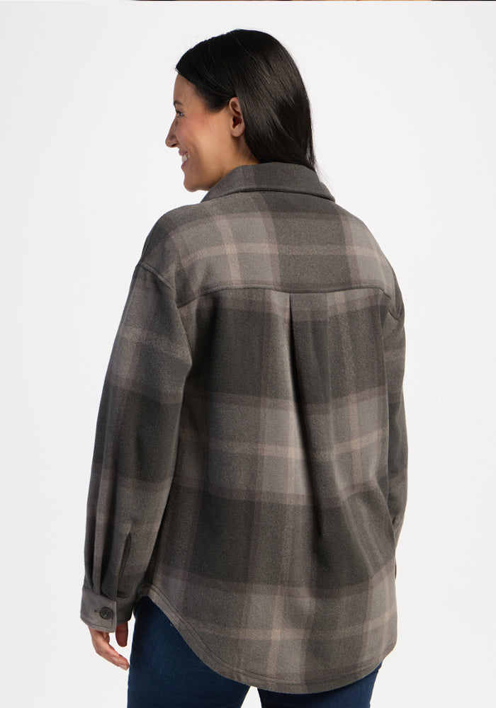 Smiling woman with long dark hair models Woolx Sawyer Shacket in Volcanic Ash Plaid, facing away from camera.