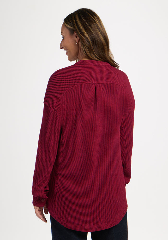 Woman facing away in Woolx Oaklynn Waffle Shacket - Beet Red, brown hair, light background.