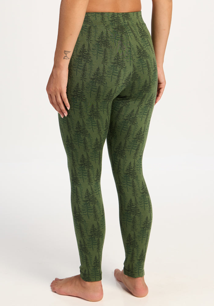 Model wears Woolx Taylor Baselayer Leggings - Forest Friends, shown from the back, barefoot on a white background.