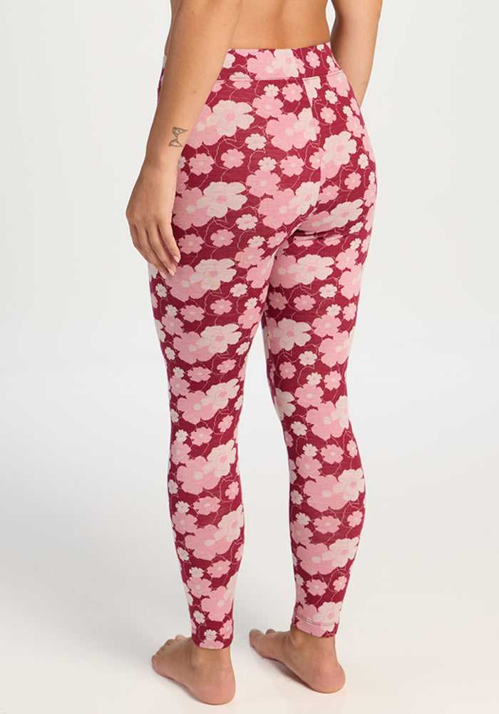 Model in Woolx Taylor Baselayer Leggings - Floral Crush, barefoot, back view, against plain light background.