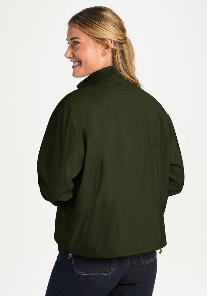 A woman viewed from behind wearing a dark green Cooper Windbreaker - Duffel Bag.