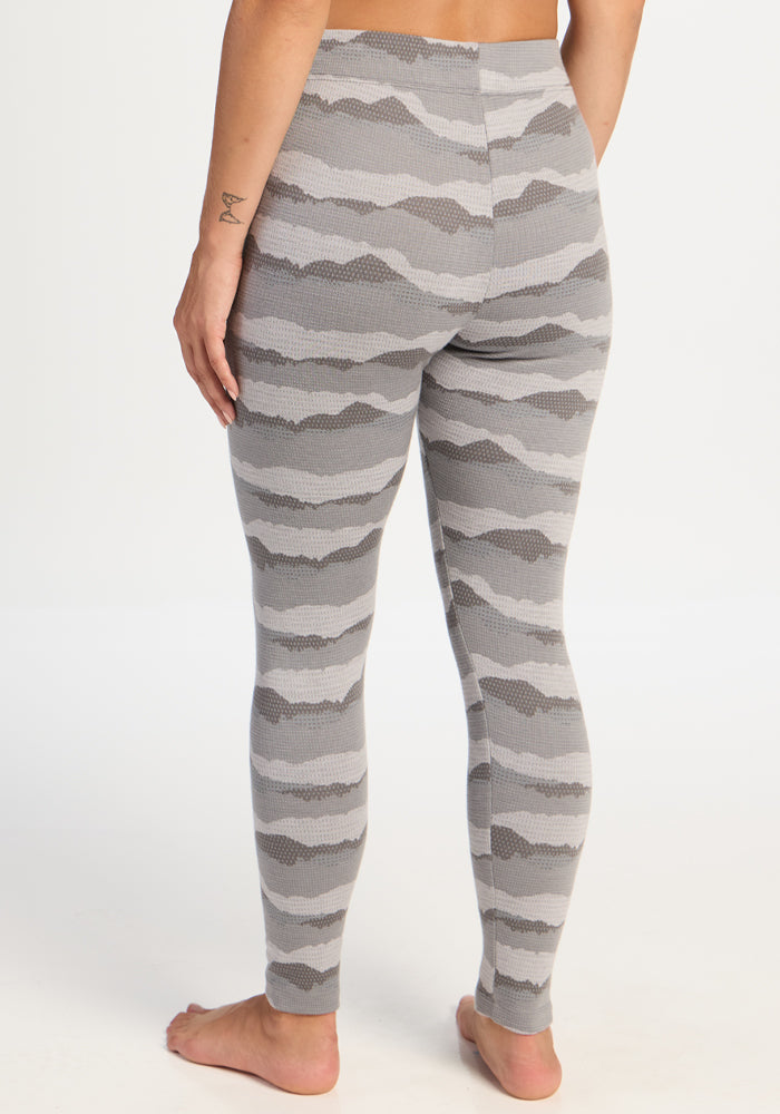 Person in Woolx Taylor Baselayer Leggings - High Peaks, barefoot, shown from the back against a plain backdrop.