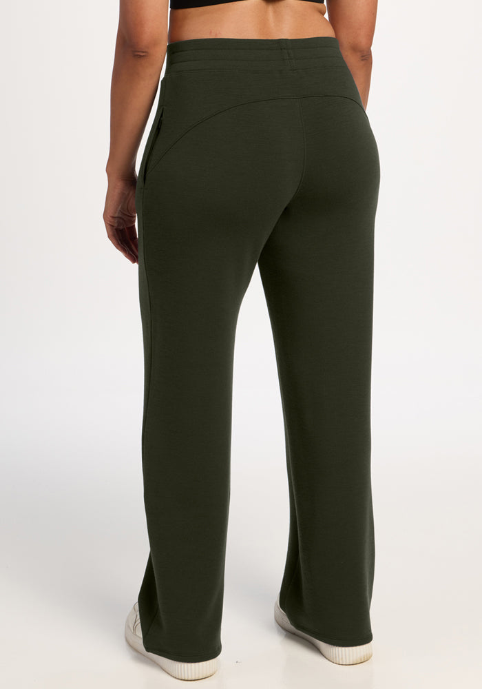 Person in Woolx Bree Lounge Pants (Duffel Bag), relaxed fit, with white sneakers, seen from the back.