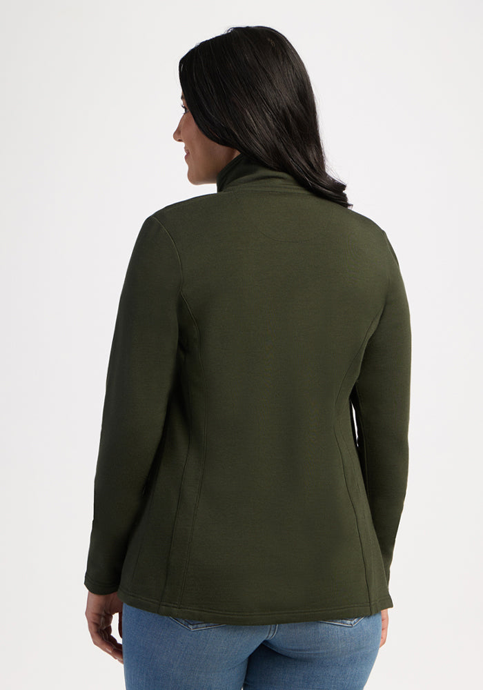 Woman with long dark hair in Woolx Finley Zip Up Sweatshirt - Duffel Bag and blue jeans, facing away from camera.