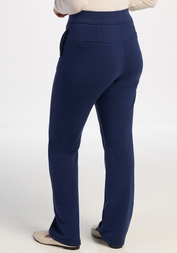 Person in Woolx Emerson Straight Leg Pants - Ocean Cavern and beige shoes, back view against a plain light background.