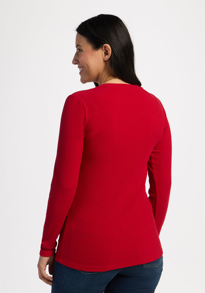 Woman with long dark hair, smiling, wears the Woolx Hadley Ribbed Crew in Maraschino Cherry and blue jeans.